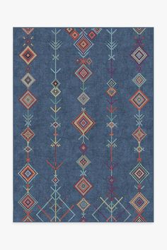 a blue rug with different colored designs on it