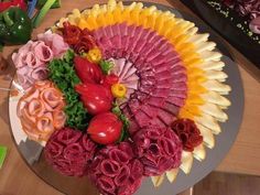 a platter filled with lots of different types of meats and veggies