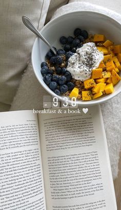 an open book is next to a bowl of food