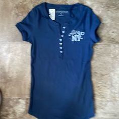 Brand New Blue T-shirt With Button Closure And Crew Neck, Navy Casual Tops With Button Closure, Casual Navy Tops With Button Closure, Blue Crew Neck Shirt With Button Closure, Casual Blue T-shirt With Buttons, Blue Casual Tops With Button Closure, Fire Shoes, Movie Ideas, Blue Shirts