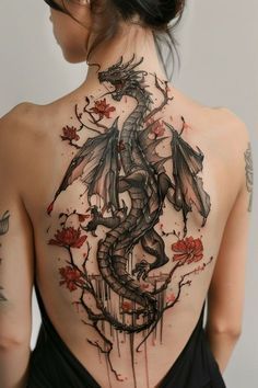 the back of a woman's body with tattoos on it