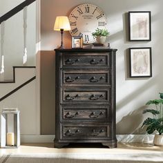 an old chest of drawers with a clock on top