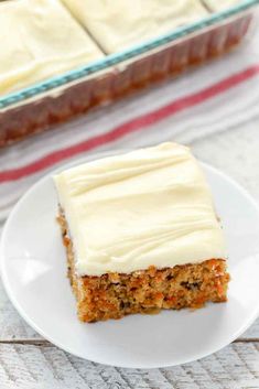 a piece of carrot cake sitting on top of a white plate next to a pan