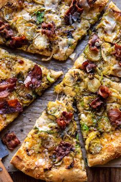 a pizza cut into four slices on top of a wooden cutting board