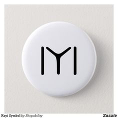 a white button with the letter m in black on it's front and back sides