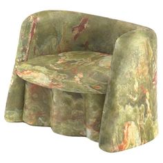 an upholstered green chair with red and orange designs