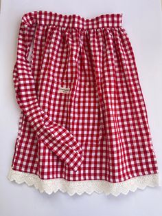 a red and white checkered skirt with scalloped hems on the bottom