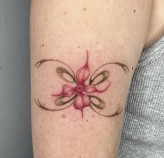 a woman's arm with a flower tattoo on it