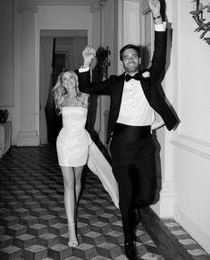 a man in a tuxedo and a woman in a white dress are dancing