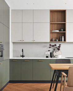 a kitchen with wooden floors and white cabinets