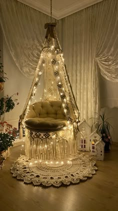 a bed with lights on it in the middle of a wooden floor next to a christmas tree