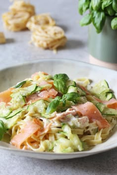 a white plate topped with pasta and vegetables