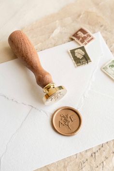 a rubber stamp sitting on top of a piece of paper next to some postage stamps