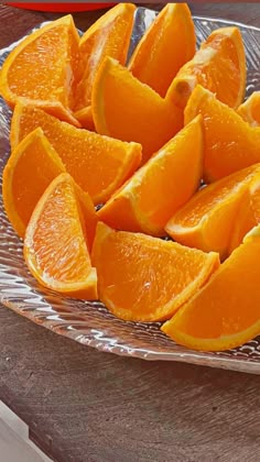 sliced oranges on a glass plate sitting on a table