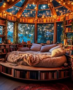 a bed with lots of books on it in a room filled with windows and lights