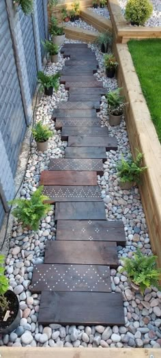 a wooden walkway surrounded by rocks and plants