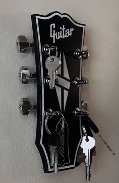 a guitar key holder with several keys attached to it