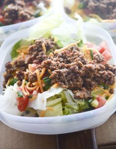 two plastic containers filled with food on top of a table