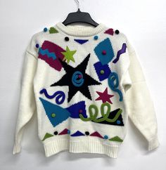 Vintage 80's Gitano 3D Knit Long Sleeve Sweater Ivory Colorful Pullover Large.   If you have any questions don't hesitate to message us. Returns accepted within 30 days. Buyer pays return shipping and item must be in condition you received it in. There will a 20% restocking fee on all returns.  Thank you for shopping with The Brinkley 7. Have a wonderful day! White Retro Knitted Sweater, Multicolor Retro Winter Sweater, Retro Multicolor Winter Sweater, Cream Retro Winter Sweater, Retro Cream Crew Neck Sweater, Retro Crew Neck Cream Sweater, Multicolor 90s Sweater For Winter, Multicolor 90s Style Winter Sweater, 90s Multicolor Sweater For Winter