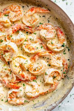 a skillet filled with shrimp and sauce