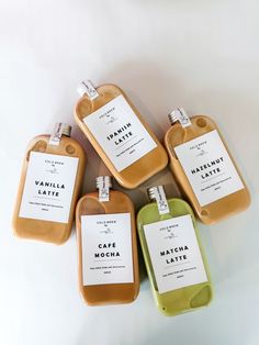 six soap bottles with labels on them sitting next to each other in front of a white background