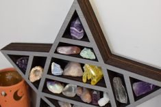 a star shaped shelf with various rocks in it