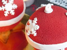 two red cakes with white snowflakes on them