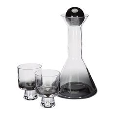 three glasses and a decanter on a white background