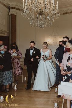 a bride and groom walking down the aisle at their wedding ceremony in an old building