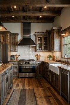 a kitchen with wooden floors and lots of counter space, including a stove top oven