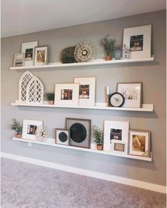 some white shelves with pictures and frames on them