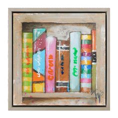 a painting of colorful books on a white background in a frame with the words good times painted on them