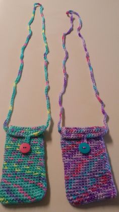 two small purses made out of knitted material with buttons on the handles and straps