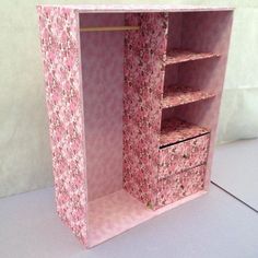 a pink flowered closet with drawers on the bottom and shelves in the top half