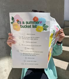 a person holding up a sign that says it's a summer bucket list in front of stairs