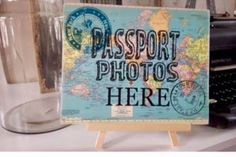 there is a sign that says passport photos here next to a glass and typewriter