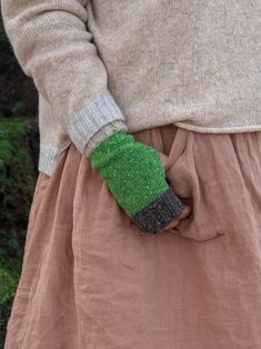 Functional and warm, our unisex fingerless gloves feature an insulating textured stitch in flecked green yarn with a contrasting bright green colour thumb. With your fingers free to move, you can easily tackle outdoor tasks, type, and use your touch screen while keeping your hands warm. These gloves are knitted in British wool and feature a soft, close-fitting rib cuff that fits snugly around your wrists, preventing cold air from creeping in. Suitable for both men and women, these gloves are a p Wool Fingerless Gloves, Gloves Knitted, Green Yarn, Your Touch, Wool Mittens, Fingerless Gloves Knitted, Fingerless Mittens, Fashion Revolution, Wrist Warmers