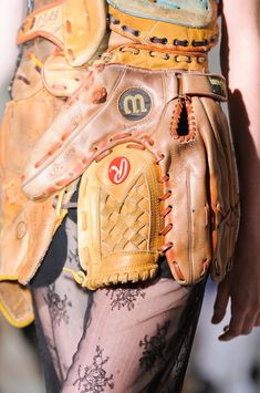 a close up of a catchers mitt on the back of a woman's leg