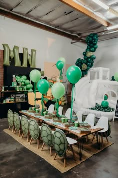 the table is set up with green balloons