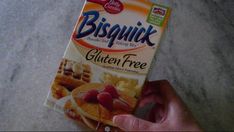 a box of bisquink gluten free is held up by someone's hand