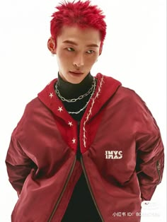 a young man with red hair and piercings wearing a jacket that says hypsis