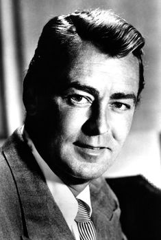 a black and white photo of a man in a suit