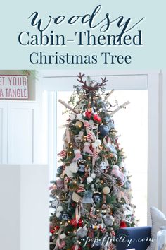 a christmas tree with red, white and blue ornaments on it in front of a window