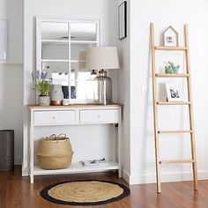 a white table with a ladder and pictures on it