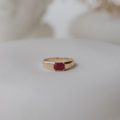 Make a bold statement with this exquisite Ruby Signet Ring, crafted in 14k solid gold. Featuring a stunning 6x4 mm emerald-shaped ruby, this ring exudes elegance and sophistication. The band starts at a width of 5 mm at the top and tapers gracefully to 2.30 mm at the bottom, ensuring both style and comfort. Material: 14-karat solid gold Gold Colors: Yellow, rose, white Ruby: 6x4 mm emerald-shaped ruby Band Width: 5 mm at top, tapering to 2.30 mm at bottom Ruby Signet Ring, Signet Engagement Rings, Ruby Bands, Ringe Gold, Curved Wedding Band, Solid Gold Rings, Ruby Ring, Gold Diamond Rings, Signet Ring