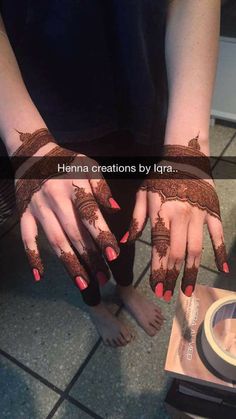 henna designs by lyra on the hands and feet of a woman with red nails