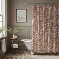 a bathroom with a bathtub, shower curtain and rugs in the flooring