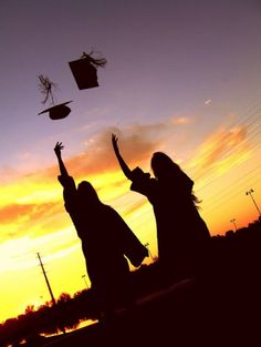 two girls are throwing their hats in the air at sunset with one girl wearing a graduation cap and gown