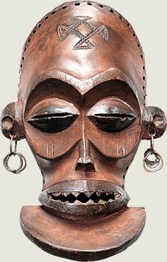 a wooden mask with earrings on it's head