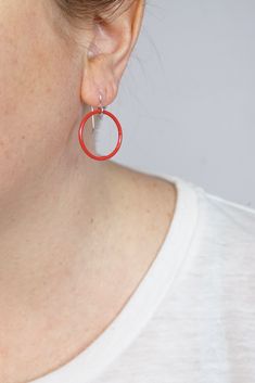 These lightweight circle earrings are sure to become your new favorite pair. An update on classic hoops, each circle retains evidence of their making - a small dot marks the spot where I hand-weld each earring. Approximately 1 1/4" tall (including ear wires) and 7/8" wide. Powder coated in a bright red color. Sterling silver ear wires. Handcrafted in my Pennsylvania studio. Ships in 1-2 business days. Comes in a gift box. Treat yourself or a loved one! Red Small Hoop Earrings For Everyday, Red Sterling Silver Hoop Earrings, Small Red Hoop Earrings For Everyday Wear, Red Sterling Silver Round Hoop Earrings, Modern Red Hoop Earrings, Modern Red Round Earrings, Small Hoop Red Earrings For Everyday, Red Handmade Hoop Earrings For Everyday, Red Hoop Jewelry For Everyday